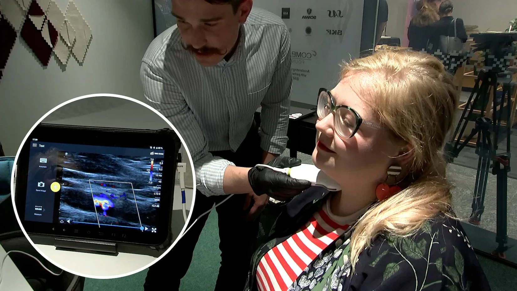 Ultrasound scan being performed on a patient, with the live scan shown on screen